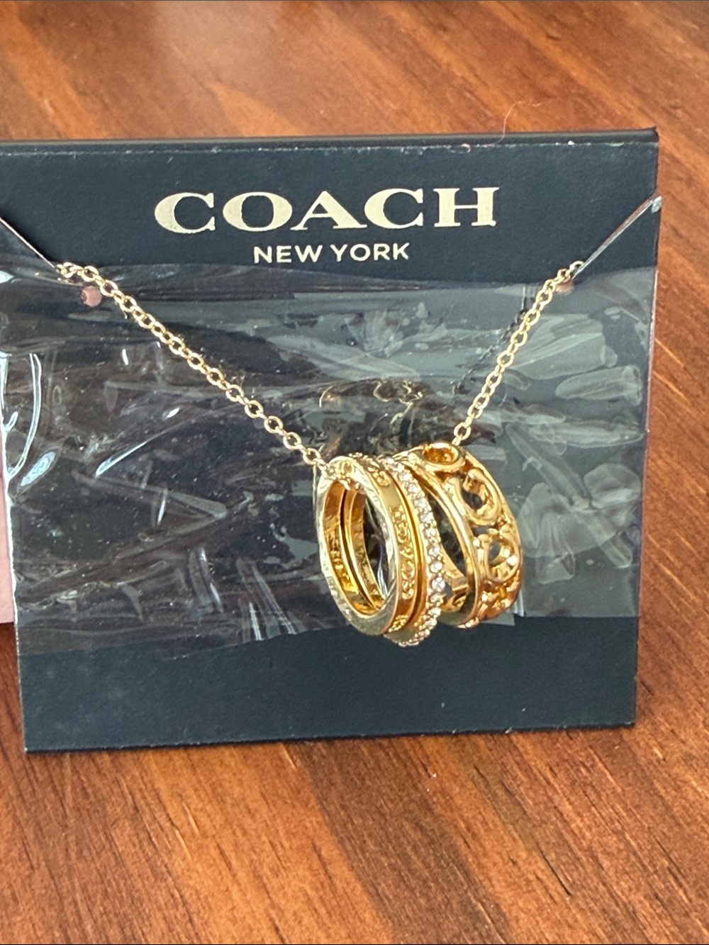 Coach Gold Triple Ring Pendant Necklace - Polished Gold Tone
